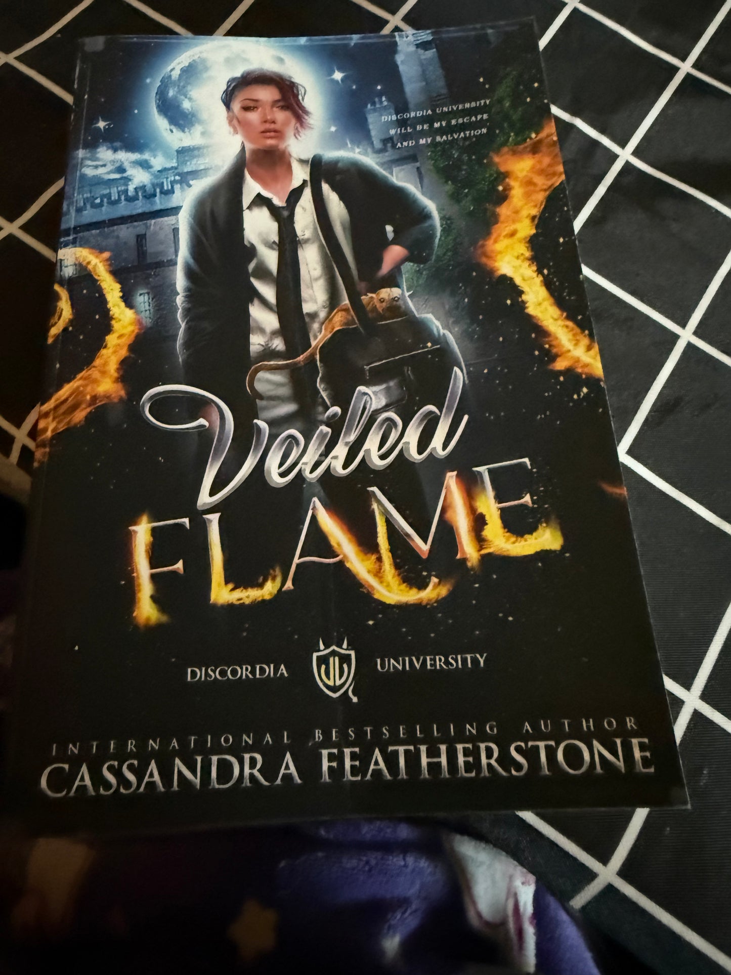 DAMAGED-Veiled Flame: A Reverse Harem Demon Academy Romance This book is non-returnable as it is being sold as damaged. The damage is a bent front cover. *** Welcome to Discordia University… let the games begin. One letter. That was all it took to change